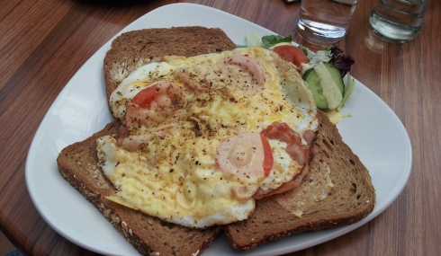 brown bread with backed egg bacon and tomato